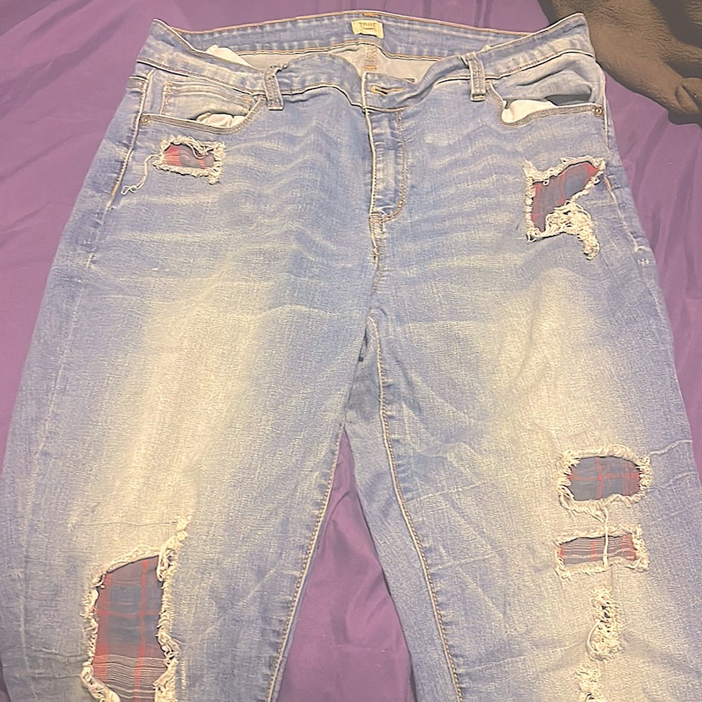 Blue jeans with plaid hole covering. Size15
